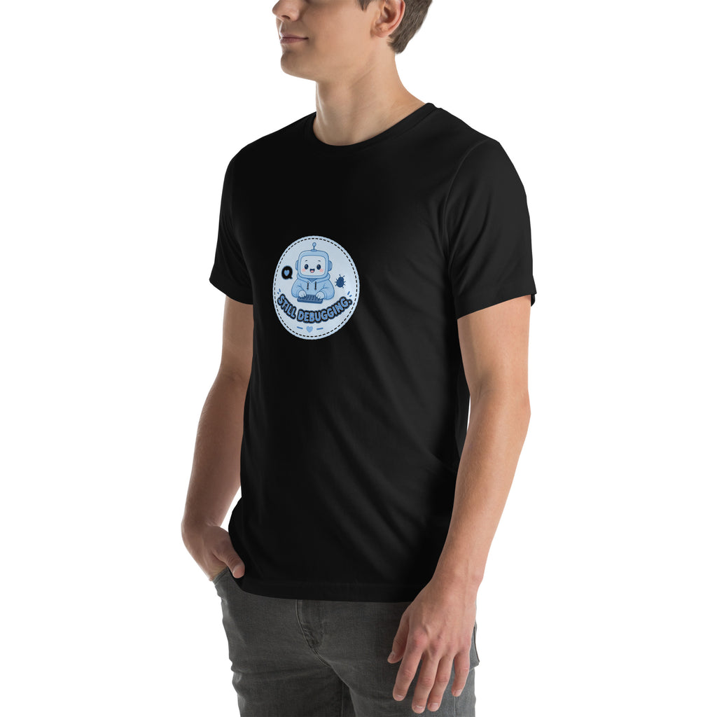 Debug Badge tee STILL DEBUGGING — cute coding robot graphic tee mockup