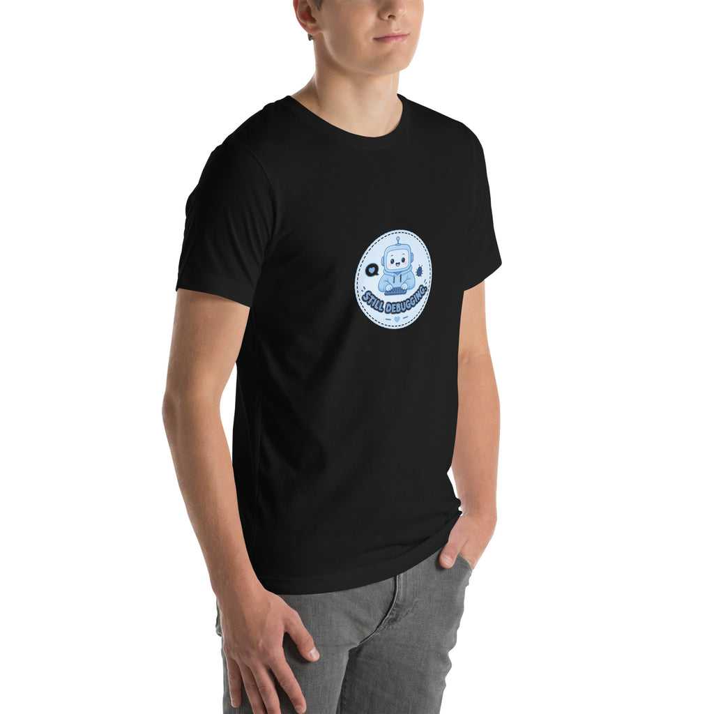 Debug Badge tee STILL DEBUGGING — cute coding robot graphic tee mockup